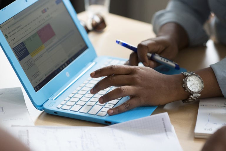 Someone is working on a laptop.