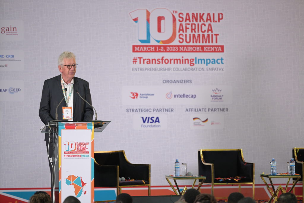 A man is standing at the podium at the he 10th Sankalp Africa Summit.