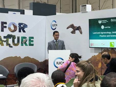 A man stands at a podium at the convention.